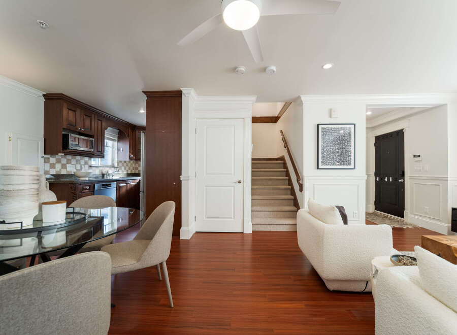 Step into this beautifully appointed living space, featuring a modern open-concept layout that seamlessly connects the dining area, kitchen, and living room.