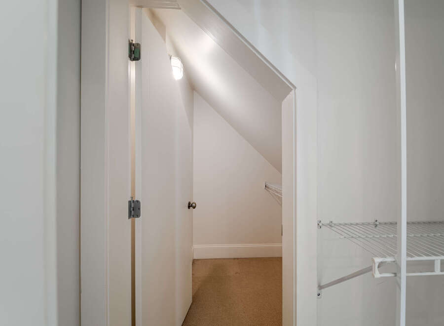 Discover ample storage solutions in this home, featuring a spacious walk-in closet with built-in shelving.