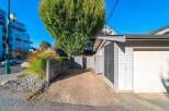 Discover this charming property featuring a paved driveway leading to a spacious garage, perfect for vehicle storage or a workshop.