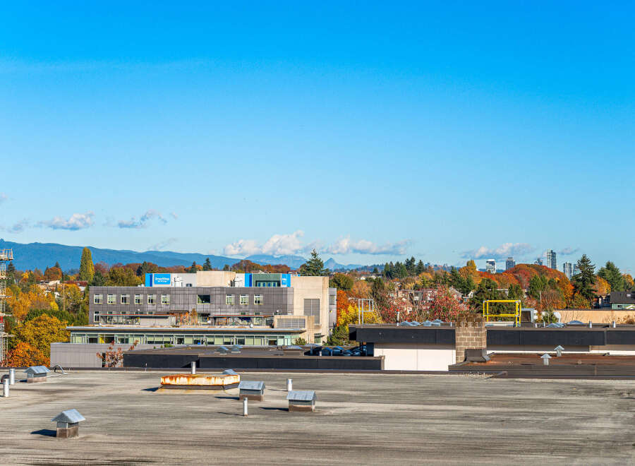 Discover this prime real estate opportunity with a sprawling rooftop offering panoramic views of the surrounding cityscape and distant mountains.