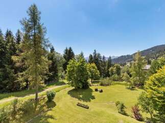 Experience the tranquility of this stunning mountain property, featuring a beautifully manicured lawn perfect for outdoor activities and relaxation.