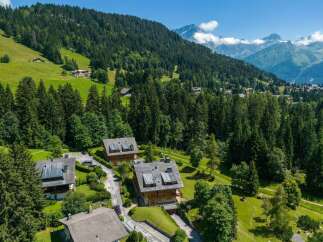 Discover this stunning alpine property nestled amidst lush green hills and dense pine forests, offering breathtaking views of majestic mountains.