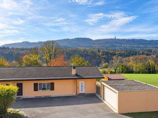 Discover this charming single-story home nestled amidst a picturesque autumn landscape.