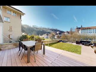 Enjoy outdoor living on this spacious deck featuring a dining set perfect for al fresco meals.