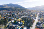 Experience the charm of this picturesque mountain town nestled amidst vibrant autumn foliage.