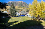 Nestled against a backdrop of majestic mountains and vibrant autumn foliage, this charming property offers a serene escape.