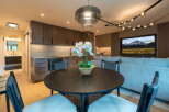 Experience modern living in this stylish studio apartment, featuring a sleek kitchen with dark wood cabinetry and a marble backsplash.