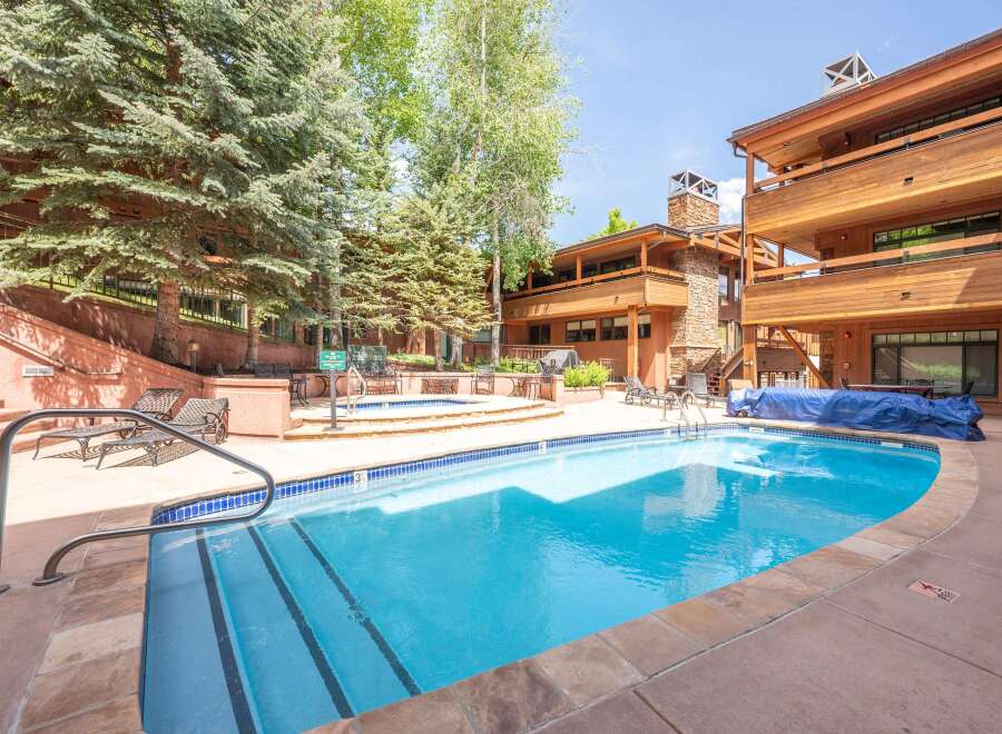 Enjoy a refreshing dip in the sparkling blue swimming pool or relax in the adjacent hot tub.