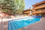 Enjoy a refreshing dip in the sparkling blue swimming pool or relax in the adjacent hot tub.