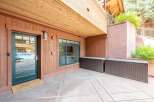 Step outside to your private patio, featuring a welcoming 'Be Our Guest' doormat and convenient storage solutions.