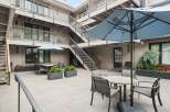 Enjoy outdoor living in this charming courtyard featuring ample seating and dining areas.