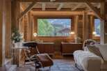 Experience rustic luxury in this charming wooden chalet, featuring a spacious living area with a stunning mountain view.