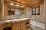 Experience rustic charm in this beautifully appointed bathroom, featuring warm wooden accents throughout the ceiling, cabinetry, and trim.