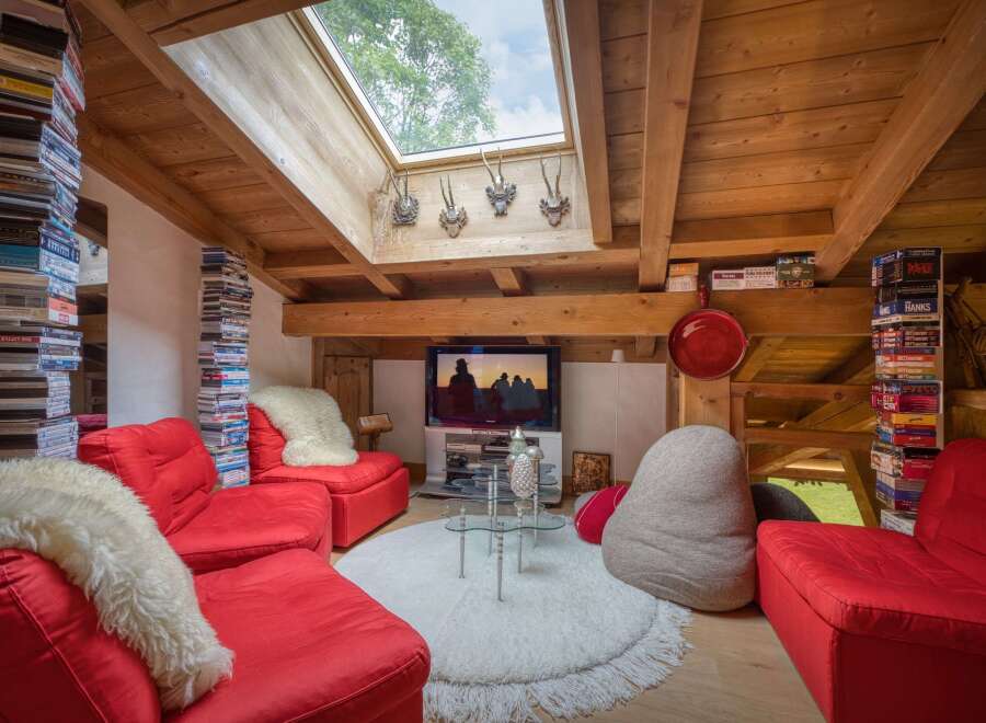 Experience cozy living in this charming attic apartment, featuring exposed wooden beams and a large skylight that floods the space with natural light.