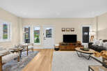 Step into this inviting living room, featuring a cozy seating area with plush chairs and a stylish sofa, perfect for relaxation.
