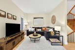 Step into this inviting living room, featuring a spacious sectional sofa adorned with plush pillows and a stylish coffee table.