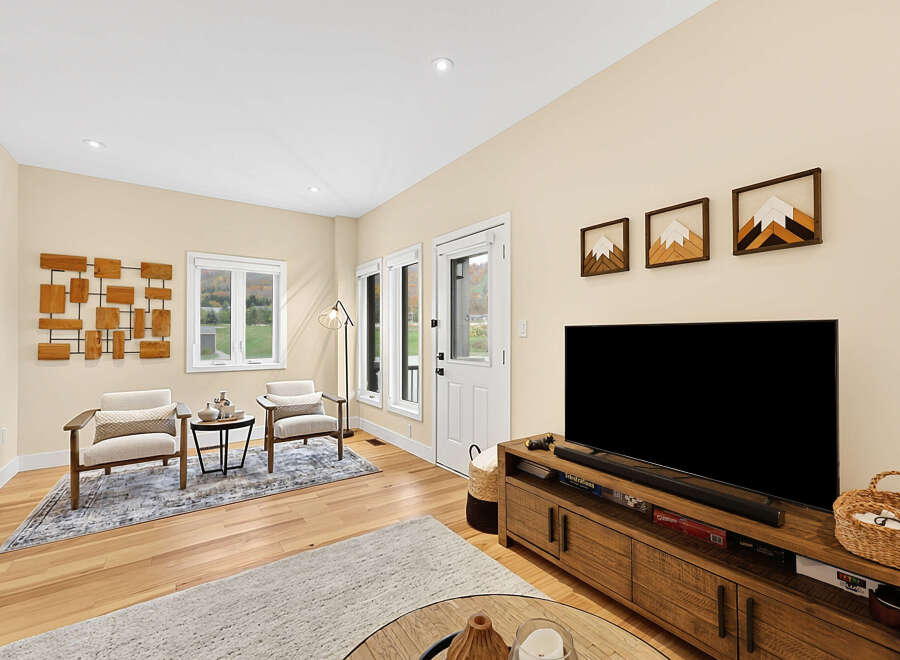Step into this inviting living room, bathed in natural light from large windows.