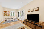 Step into this inviting living room, bathed in natural light from large windows.