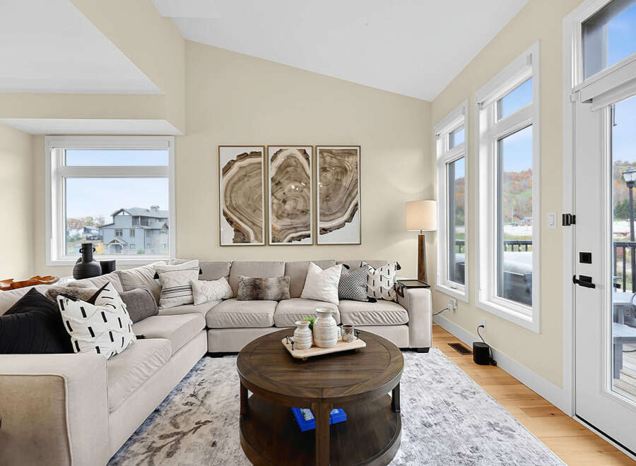 Experience modern living in this spacious living room, featuring a large sectional sofa perfect for gatherings.
