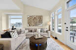 Experience modern living in this spacious living room, featuring a large sectional sofa perfect for gatherings.