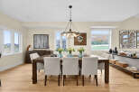 This elegant dining room features a dark wood dining table with upholstered chairs, perfect for hosting family gatherings.