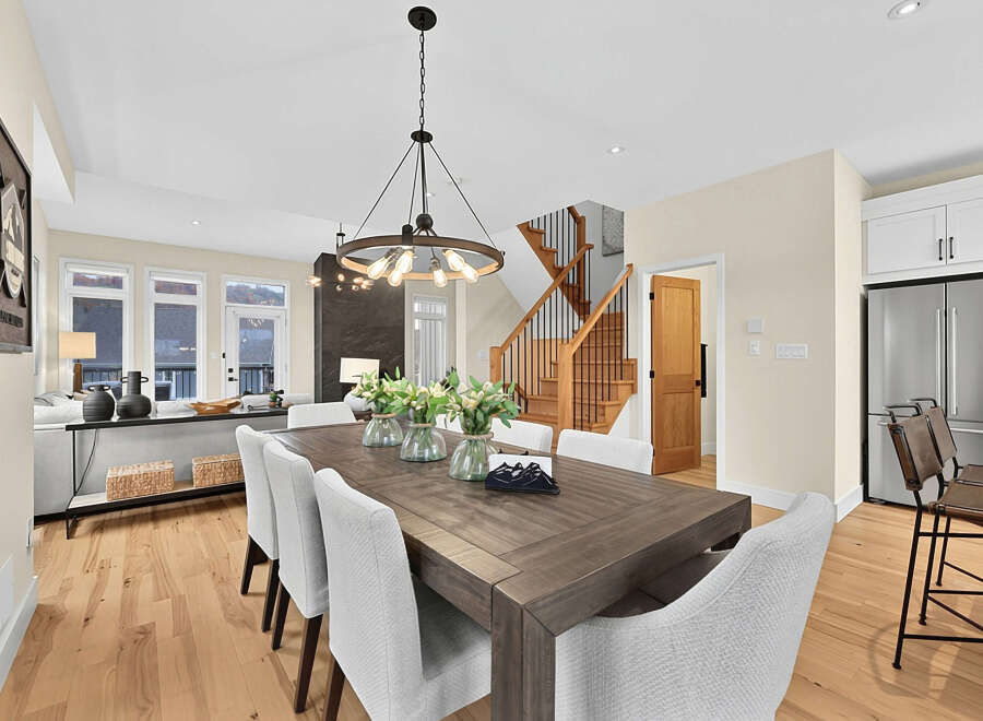 This spacious dining room features a large, dark wood dining table with comfortable upholstered chairs, perfect for family gatherings.