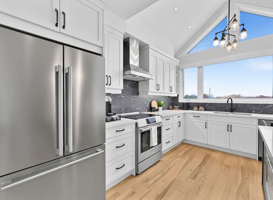 Experience modern living in this stunning kitchen featuring sleek stainless steel appliances, including a spacious refrigerator and a high-end oven.