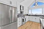Experience modern living in this stunning kitchen featuring sleek stainless steel appliances, including a spacious refrigerator and a high-end oven.