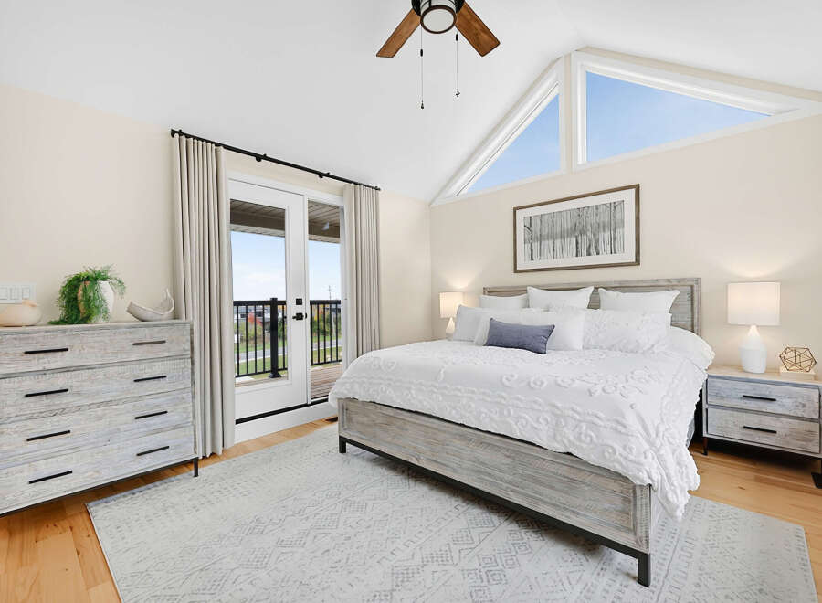 Experience coastal charm in this serene bedroom, featuring a rustic wooden bed and matching nightstands.