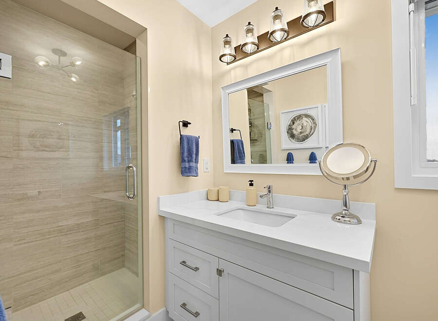 This modern bathroom features a spacious walk-in shower with elegant tiled walls, perfect for a relaxing experience.
