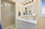This modern bathroom features a spacious walk-in shower with elegant tiled walls, perfect for a relaxing experience.