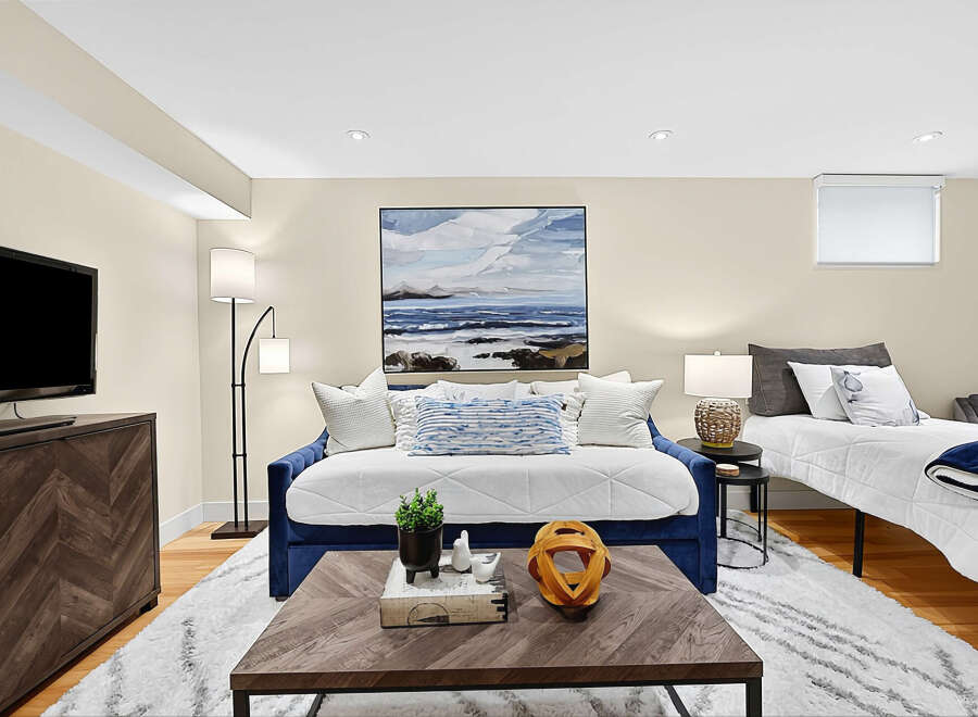 This versatile living space features a comfortable blue daybed, perfect for lounging or accommodating guests.