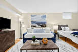 This versatile living space features a comfortable blue daybed, perfect for lounging or accommodating guests.