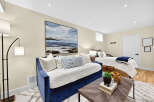 This versatile room offers comfortable sleeping arrangements with a plush blue daybed and a twin bed, perfect for guests or a multi-functional living space.