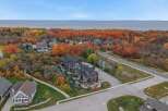 Experience the beauty of autumn from this stunning aerial view, showcasing modern townhomes nestled amidst vibrant fall foliage.