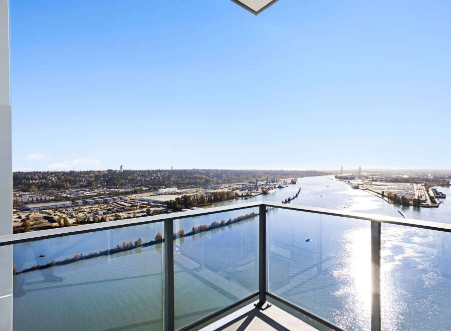 Experience breathtaking panoramic views from this stunning balcony, offering an expansive vista of the river and cityscape.