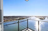 Experience breathtaking panoramic views from this stunning balcony, offering an expansive vista of the river and cityscape.