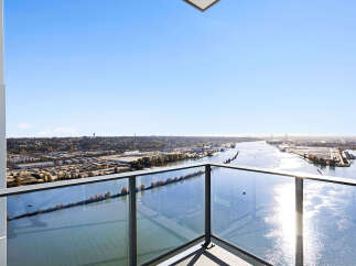 Experience breathtaking panoramic views from this stunning balcony, offering an expansive vista of the river and cityscape.