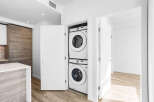Discover modern convenience with this stacked Samsung washer and dryer set, neatly tucked away in a dedicated closet.