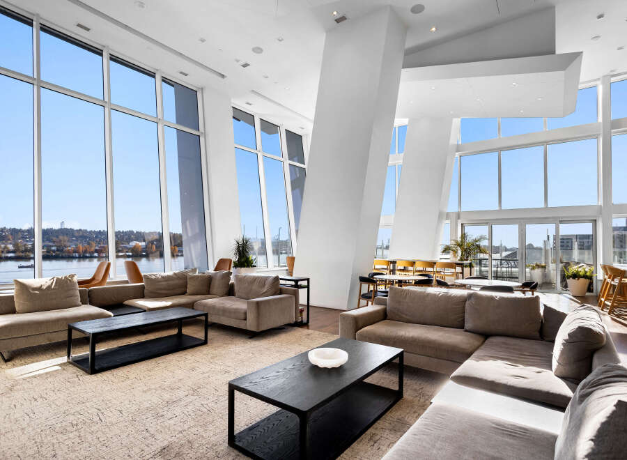 Experience breathtaking panoramic views from this stunning living space, featuring floor-to-ceiling windows that flood the room with natural light.