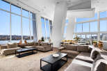 Experience breathtaking panoramic views from this stunning living space, featuring floor-to-ceiling windows that flood the room with natural light.