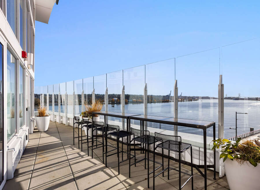 Enjoy breathtaking waterfront views from this expansive balcony, perfect for entertaining or relaxing.