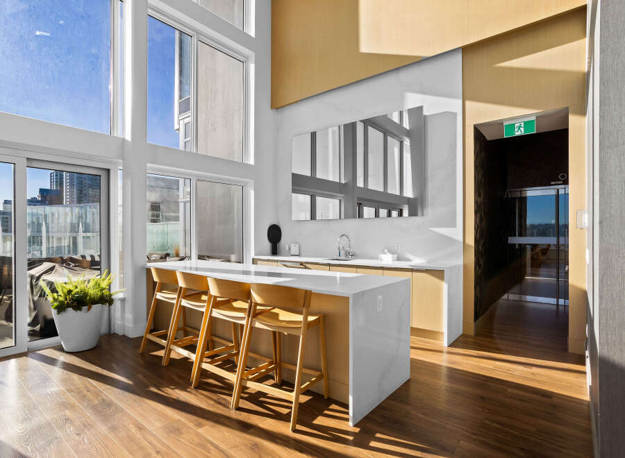 Experience modern living in this spacious apartment featuring a stunning open-concept kitchen with a large island and sleek cabinetry.
