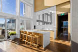 Experience modern living in this spacious apartment featuring a stunning open-concept kitchen with a large island and sleek cabinetry.