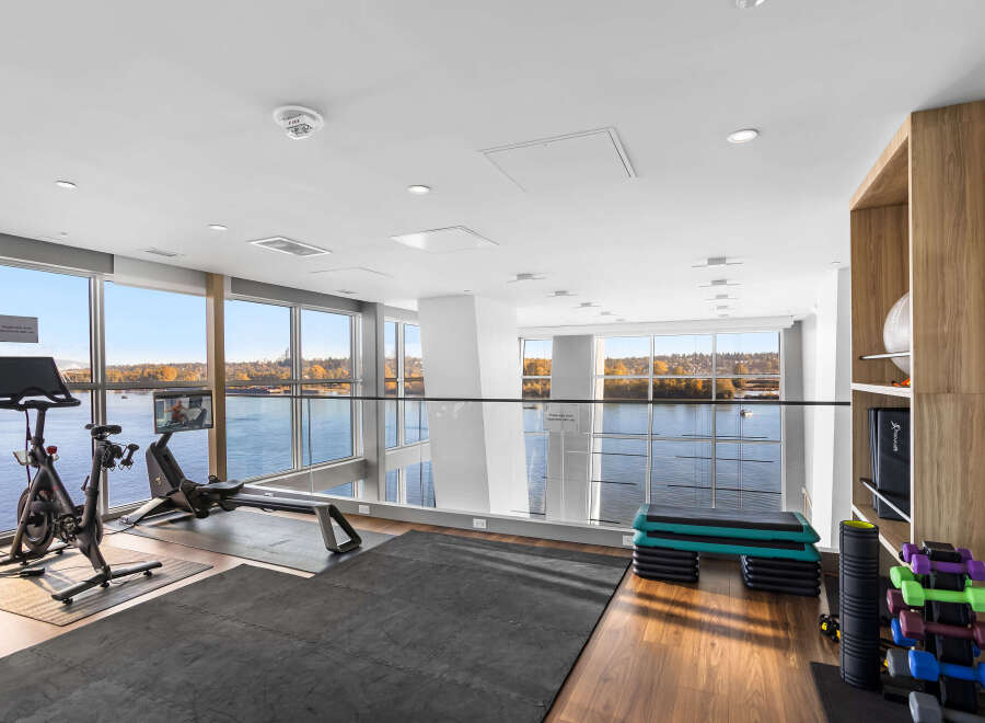 Elevate your fitness routine in this modern gym boasting stunning waterfront views.
