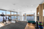 Elevate your fitness routine in this modern gym boasting stunning waterfront views.