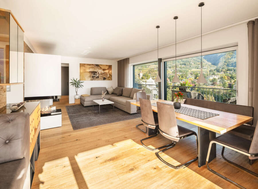 Experience modern living in this spacious open-plan apartment, featuring a comfortable living area with a sleek fireplace and a stylish dining space.