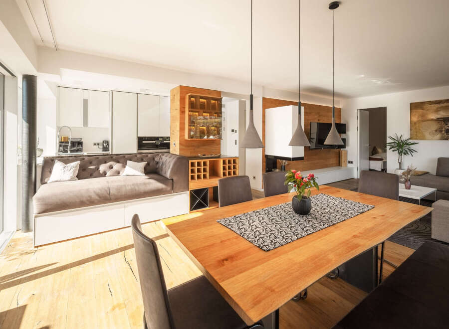 Experience modern living in this open-concept space, featuring a sleek kitchen with integrated appliances and a stylish dining area perfect for entertaining.