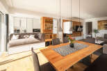 Experience modern living in this open-concept space, featuring a sleek kitchen with integrated appliances and a stylish dining area perfect for entertaining.
