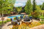 Enjoy the ultimate outdoor living experience with this stunning property featuring a sparkling swimming pool and a cozy fire pit area, perfect for relaxation and entertainment.